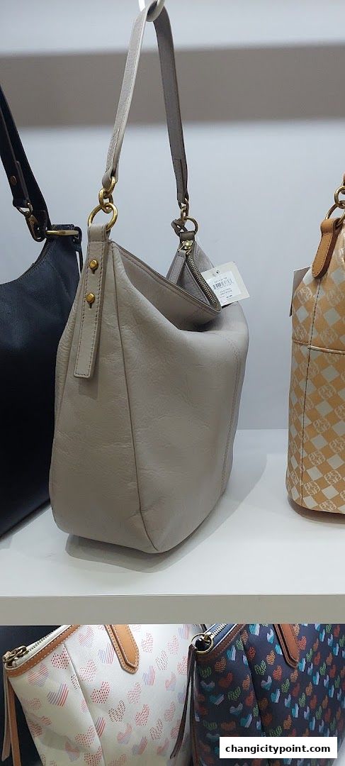 A display of stylish Fossil handbags in various colors and patterns.