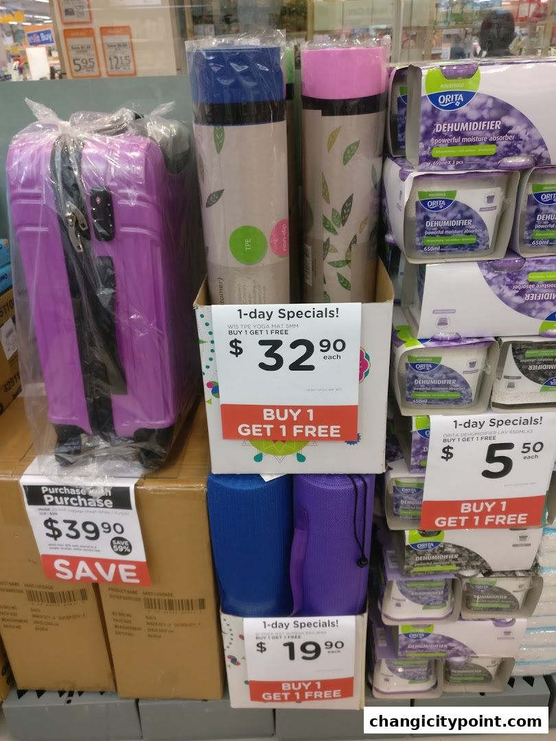 A retail display featuring luggage, yoga mats, and dehumidifiers with special offers.