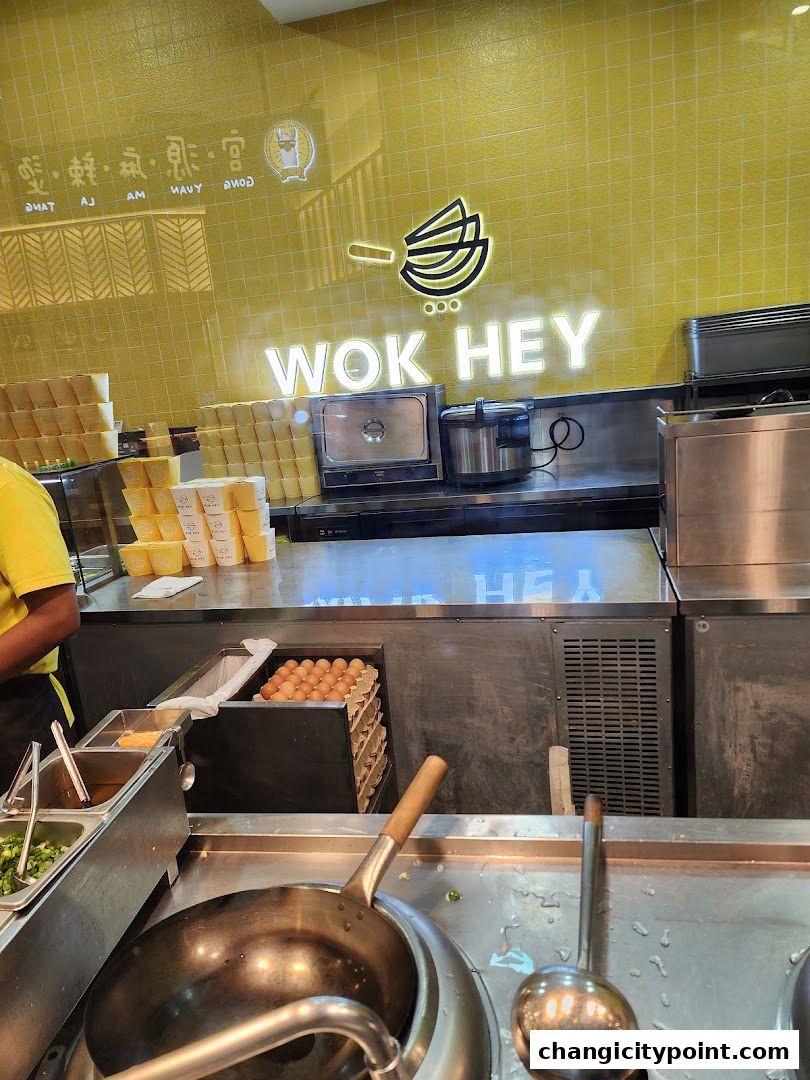 Wok Hey kitchen with fresh ingredients and cooking equipment ready for service.