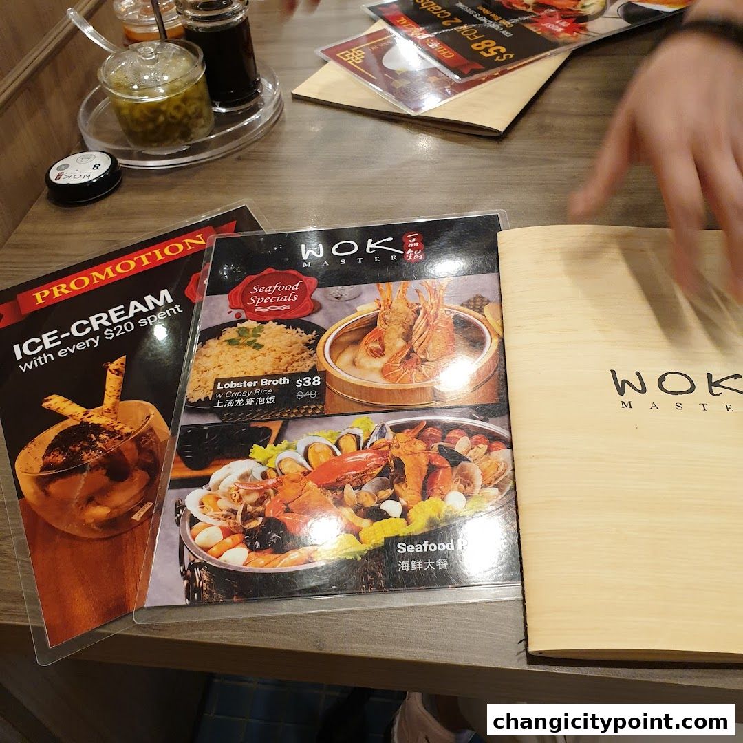 A table at Wok Master with menus, including seafood specials and an ice cream promotion.