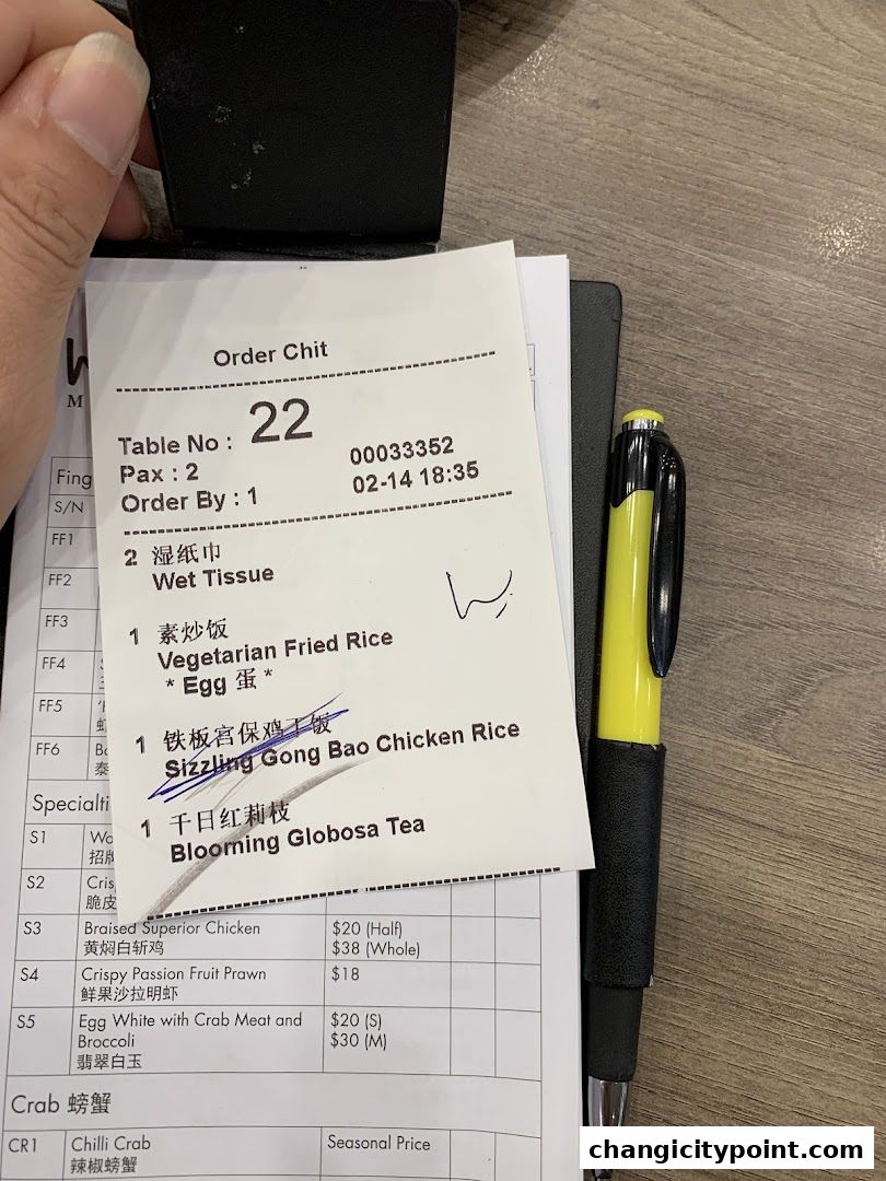 An order chit from Wok Master Changi City Point showing ordered items and prices.