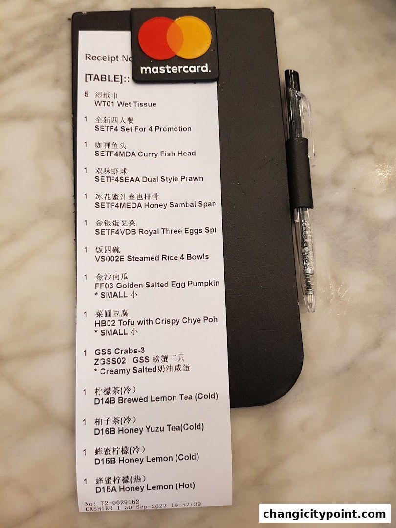 A receipt from Wok Master Changi City Point showing food and drink orders.