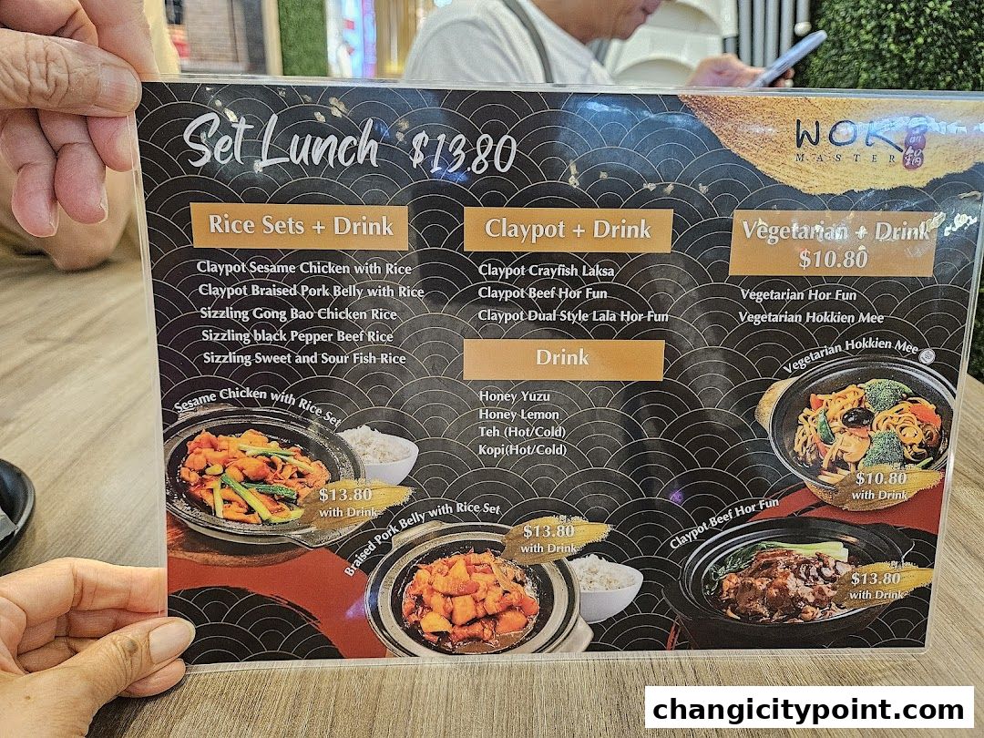 A menu from Wok Master featuring set lunches with rice sets, claypot dishes, and vegetarian options.