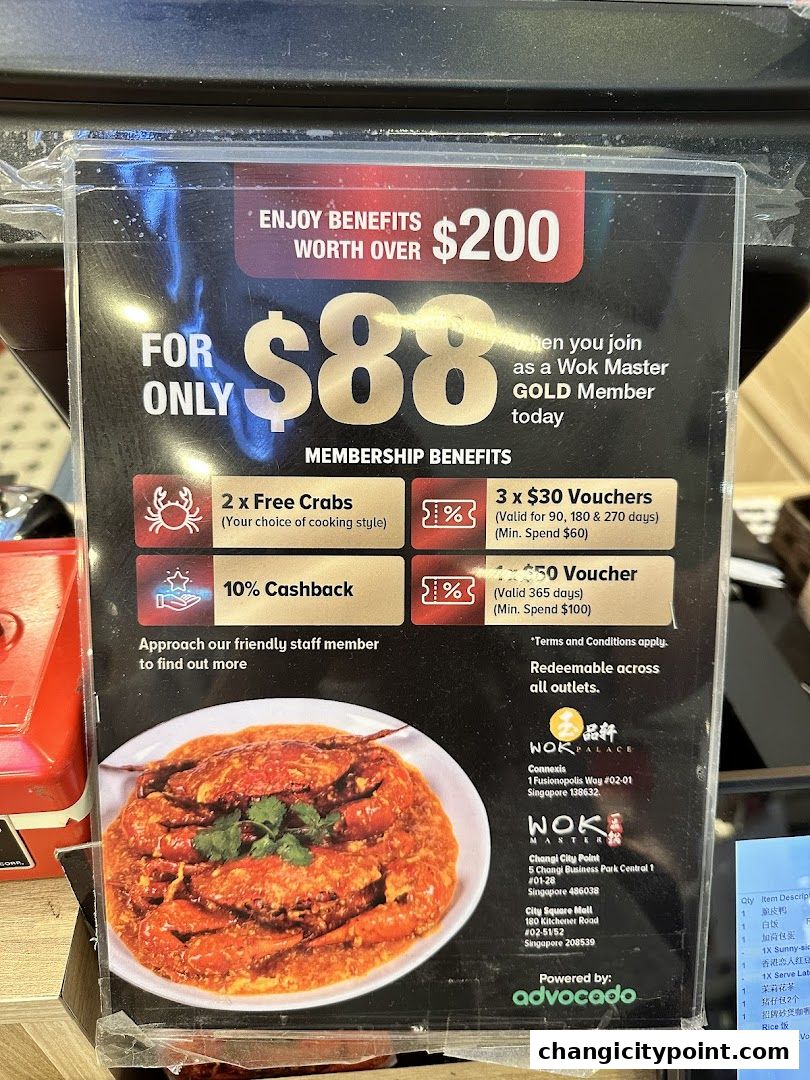 A promotional sign for Wok Master Gold Membership offering benefits like free crabs and cashback.