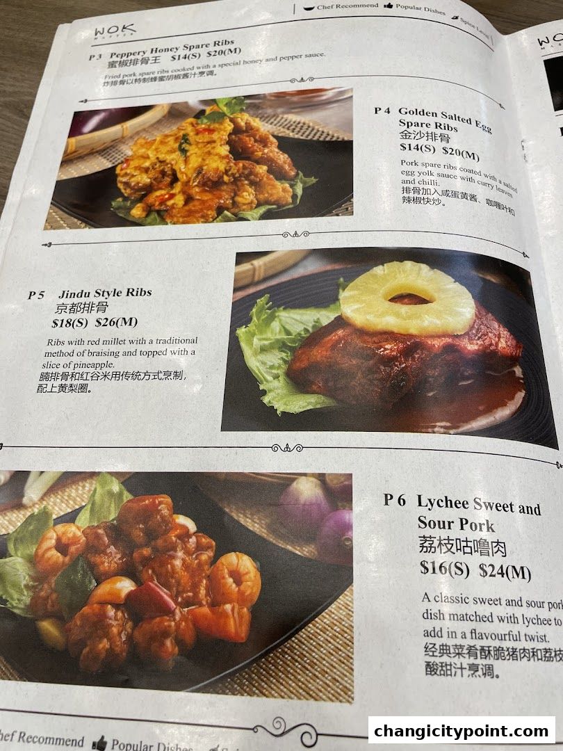 A menu page from Wok Master featuring several pork rib and sweet and sour pork dishes.