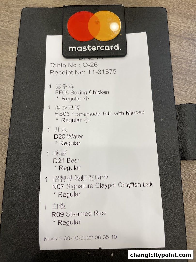 A receipt from Wok Master Changi City Point showing food and drink orders.