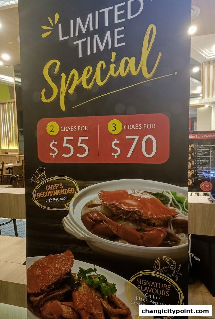 A promotional poster for Wok Master Changi City Point featuring crab specials and signature flavors.