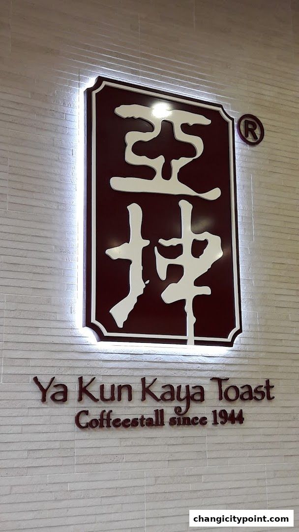 Ya Kun Kaya Toast logo and nameplate on a brick-patterned wall.