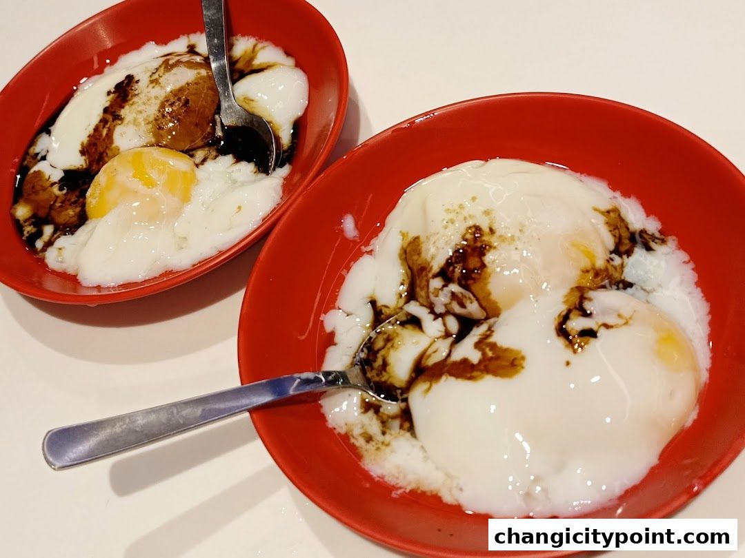Two red bowls of soft-boiled eggs drizzled with soy sauce and pepper.