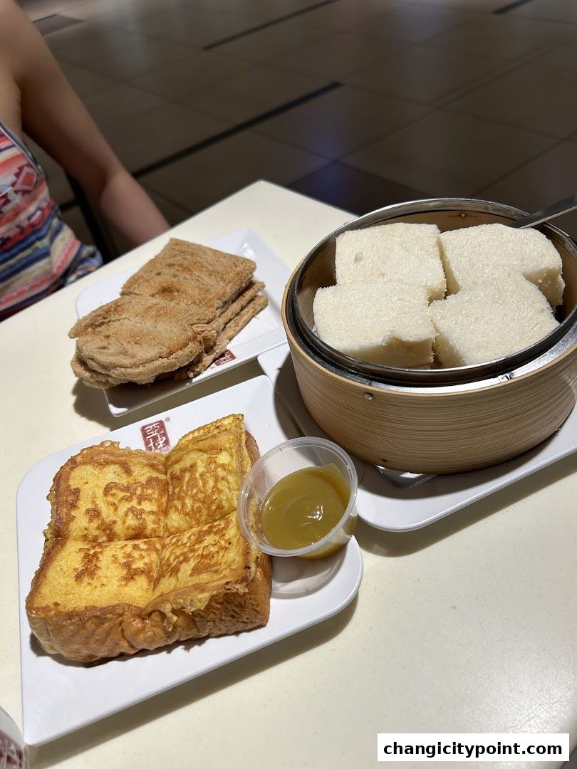 A table setting with various toast dishes and a small cup of kaya dip.