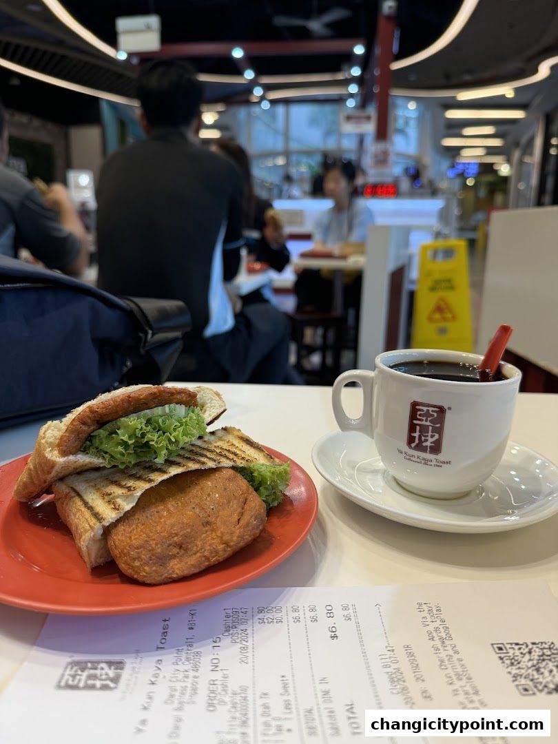 A close-up of a kaya toast sandwich and coffee at Ya Kun Kaya Toast.