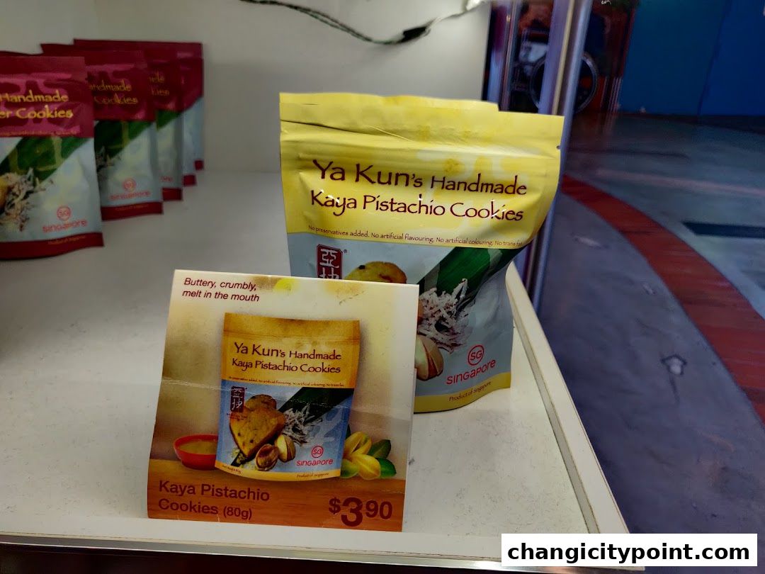 Ya Kun Kaya Pistachio Cookies are displayed on a shelf with promotional material.