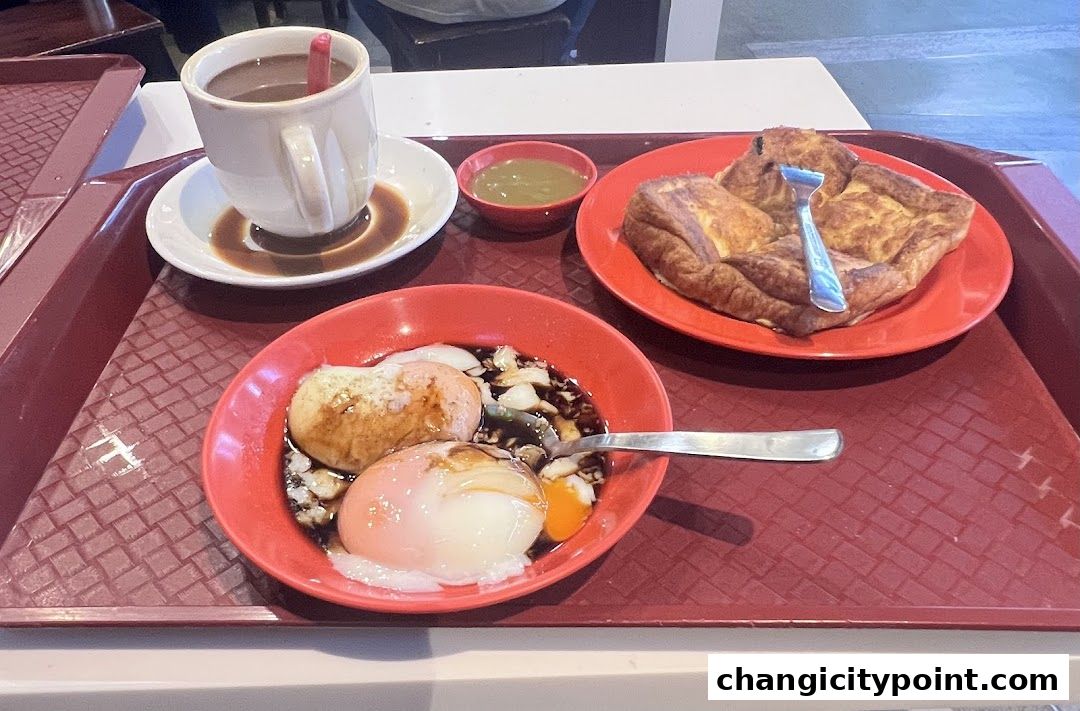 A tray with a cup of coffee, soft-boiled eggs, and toast.