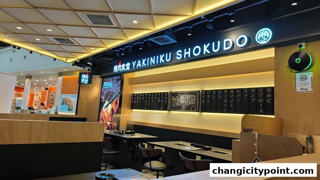 Interior view of Yakiniku Shokudo restaurant with tables and menu boards.