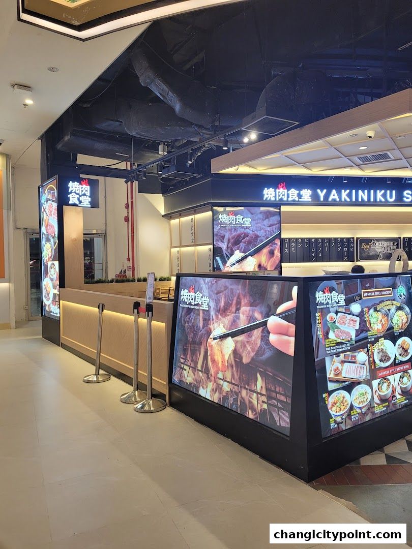 The entrance of Yakiniku Shokudo, a Japanese grill restaurant, with vibrant food displays.