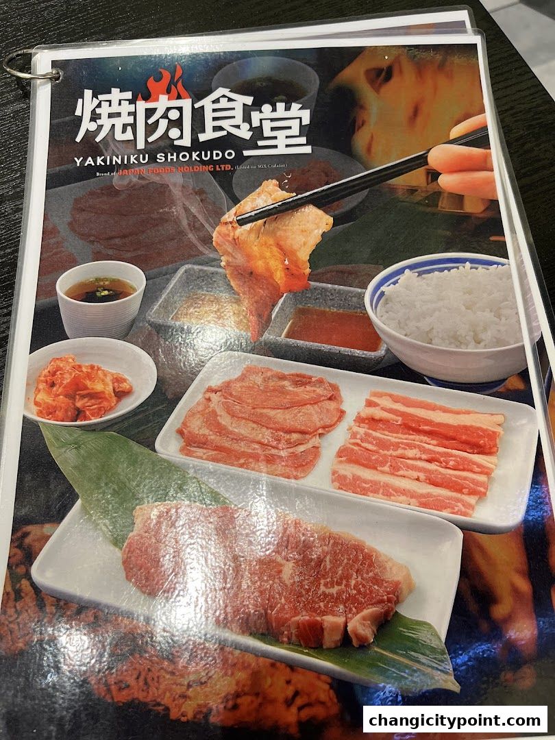 A menu page showcasing various cuts of raw meat for yakiniku, with rice and kimchi.