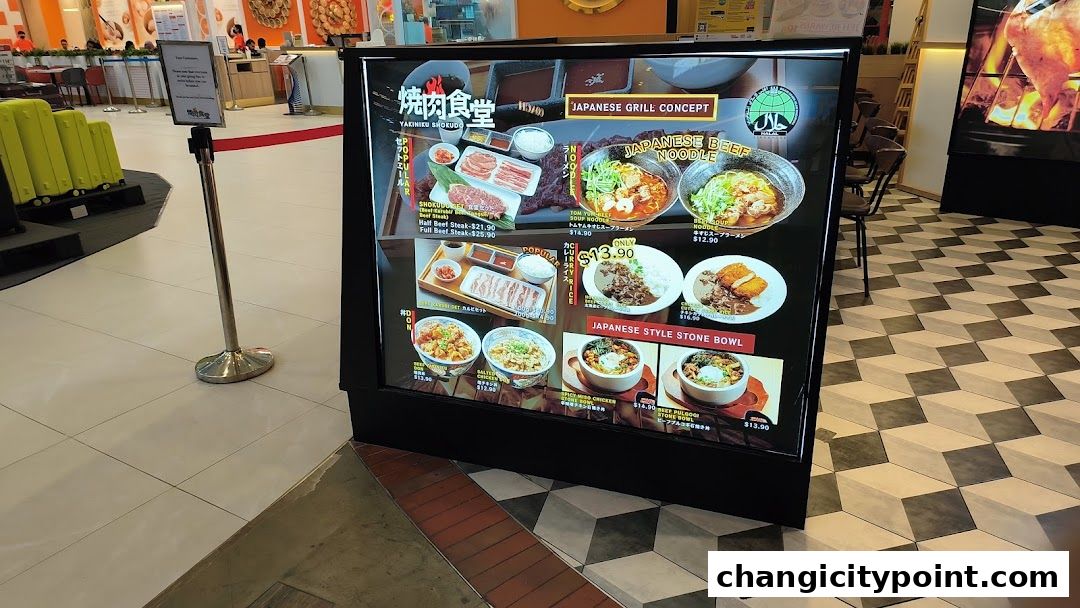 A digital menu board displays various Japanese grill dishes, noodles, and stone bowls with prices.