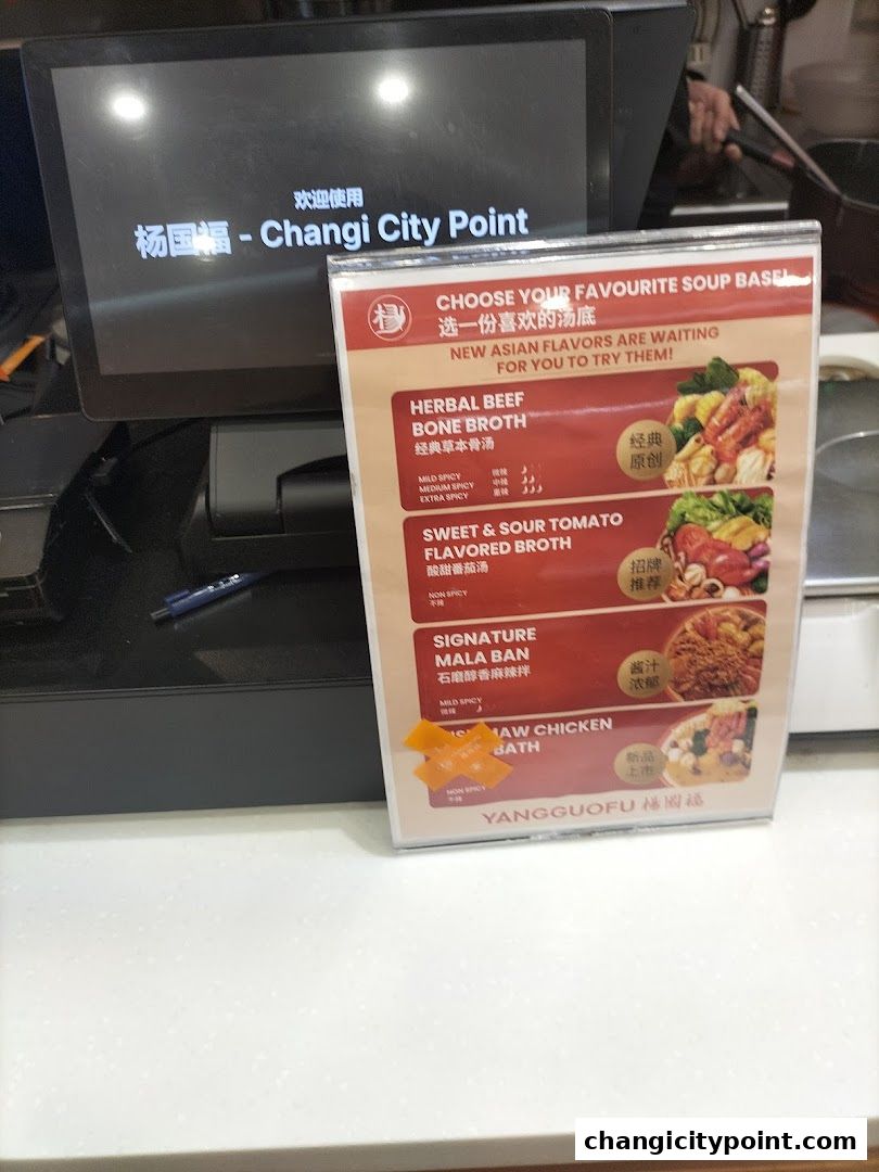 A menu board displaying soup base options for Mala Tang at Yang Guo Fu.