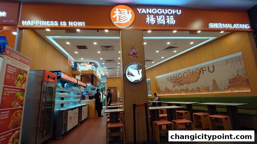 The exterior of Yang Guo Fu Mala Tang restaurant with its prominent signage and seating area.